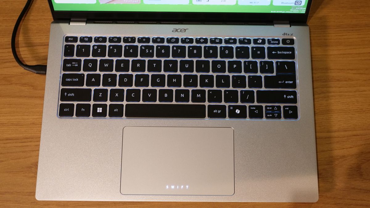 Acer Swift 14 Go (2025) on a wooden tabletop.