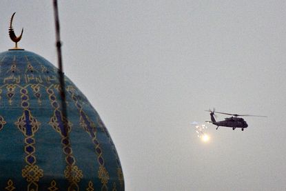 A U.S. military helicopter flies over Baghdad