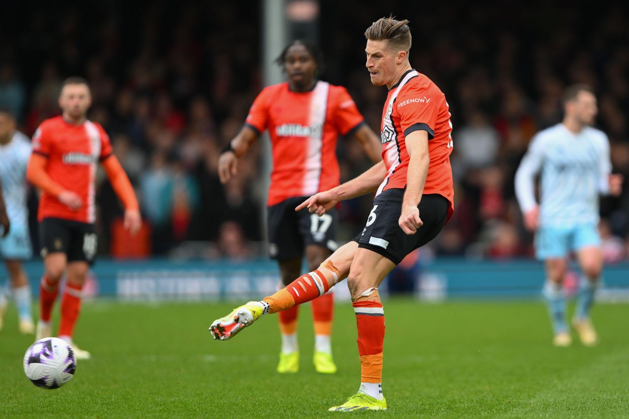 Reece Burke of Luton Town passes the ball during the Premier League match against Nottingham Forest at Kenilworth Road, March 2024