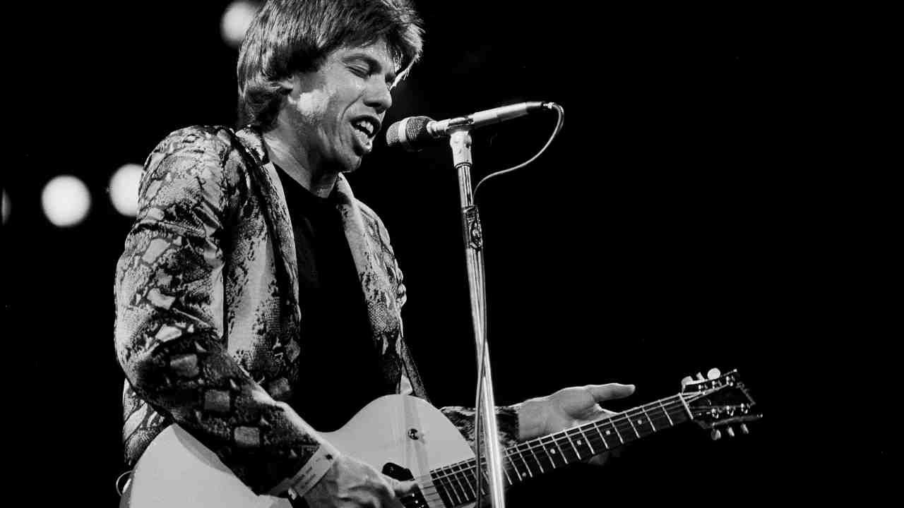 George Thorogood playing guitar onstage in the 1980s