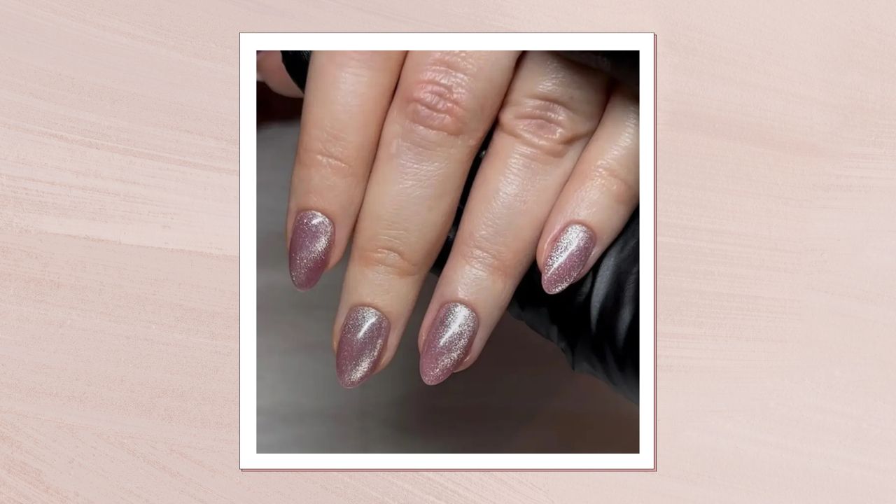 A close-up of someone&#039;s hands with pink, glittery cat eye nails by nail artist Megan Rose/ in a pastel pink template