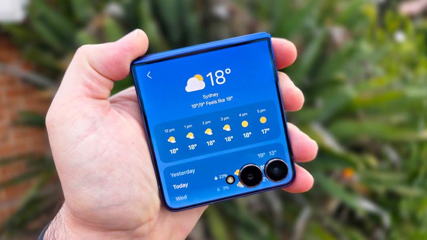 In-hand image of the Samsung Galaxy Z Flip 7 with garden in the background