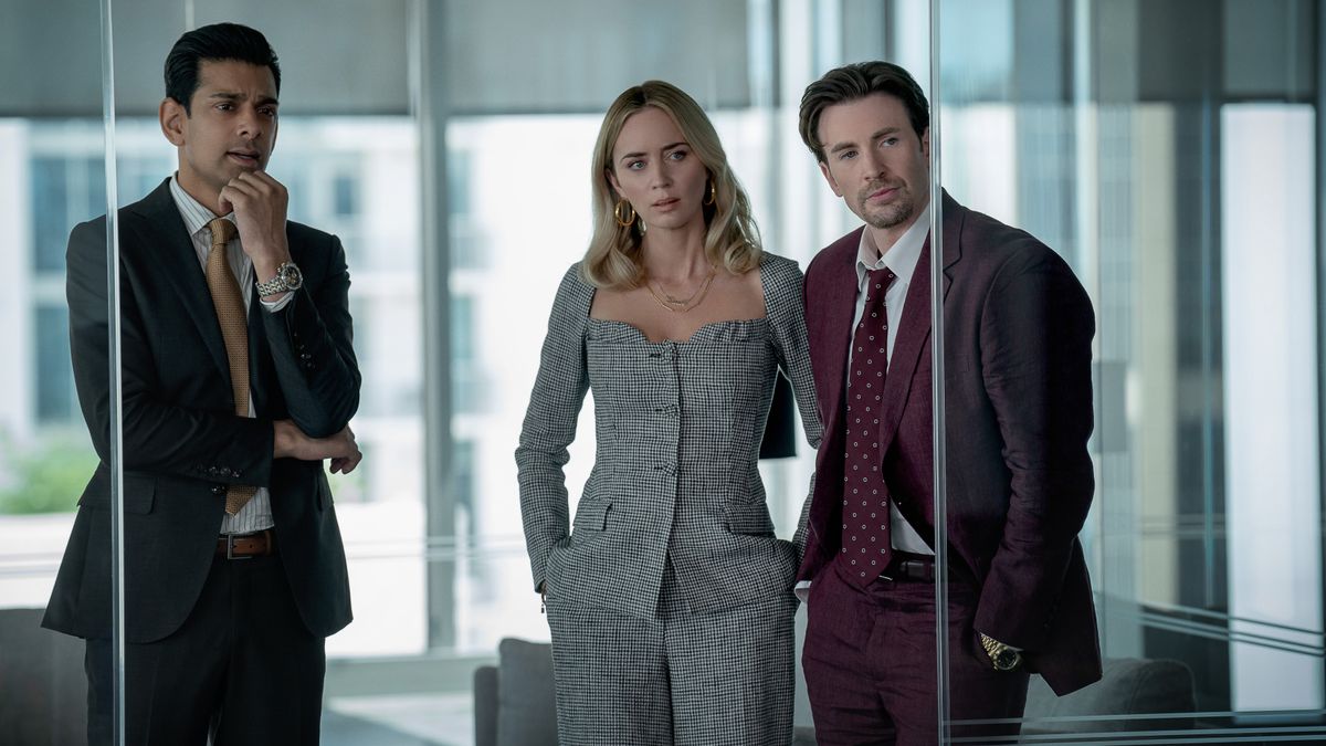 Amit Shah, Emily Blunt and Chris Evans in an office in Pain Hustlers