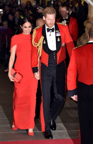Prince Harry and Meghan Markle in red at an engagement before leaving as working royals