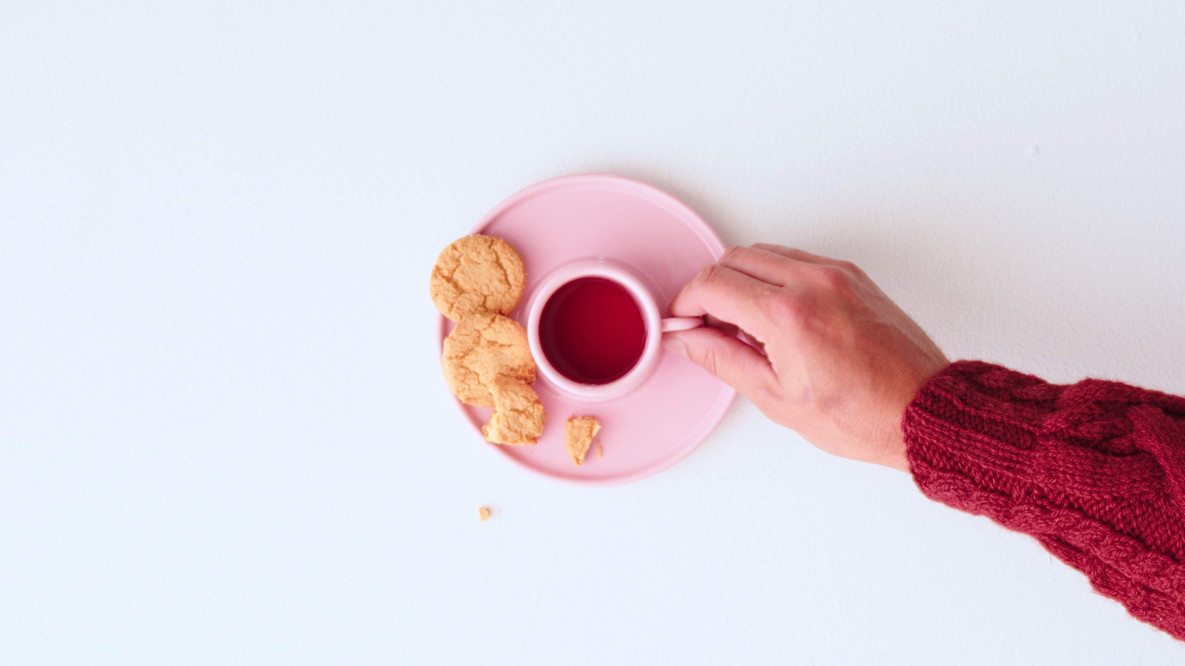 pink porcelain cup and saucer with biscuits
