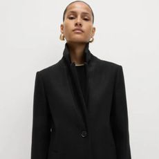 Woman wears black coat