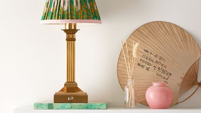 Freya rechargeable table lamp displayed on shelf with surrounding home decor