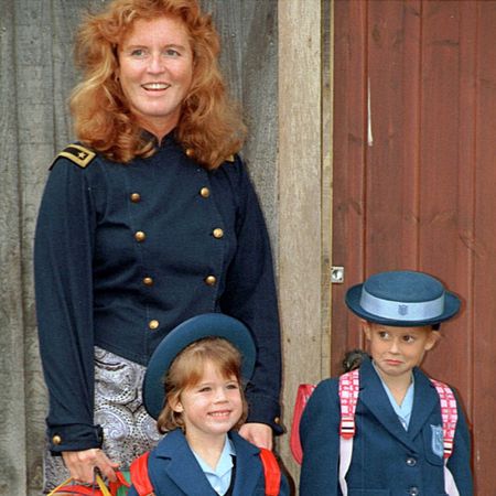 Sarah Ferguson standing with Princess Eugenie and Princess Beatrice in their school uniforms