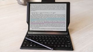 Onyx Boox Tab Ultra C propped on its keyboard case with a highlighted page displayed