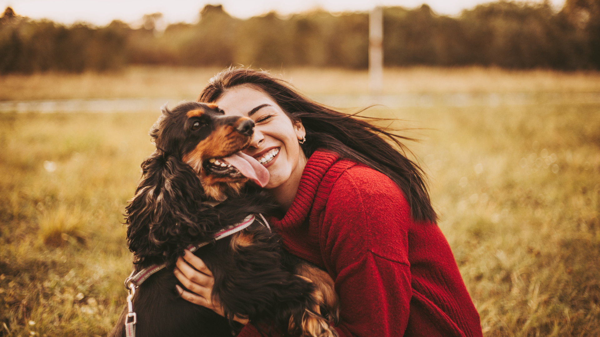 Female owner hugging her dog