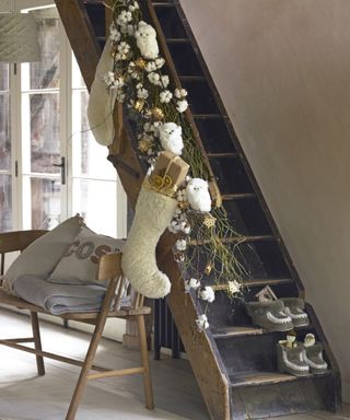 Christmas stair decor ideas with rustic cotton branches and cream wool stockings