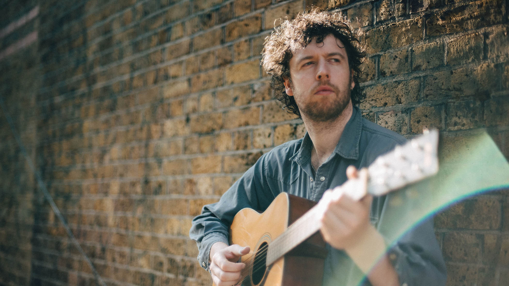Sam Grassie with his acoustic guitar