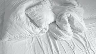 White pillows and bed sheets on top of a mattress