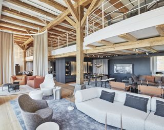 A showroom floor with sofas, chairs, armchairs and lighting hanging from the ceiling