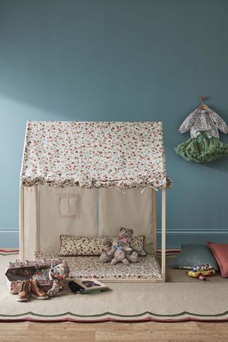 how to design a kid's room A pretty kids room with soft blue walls and a dolls house made of floral Liberty fabrics