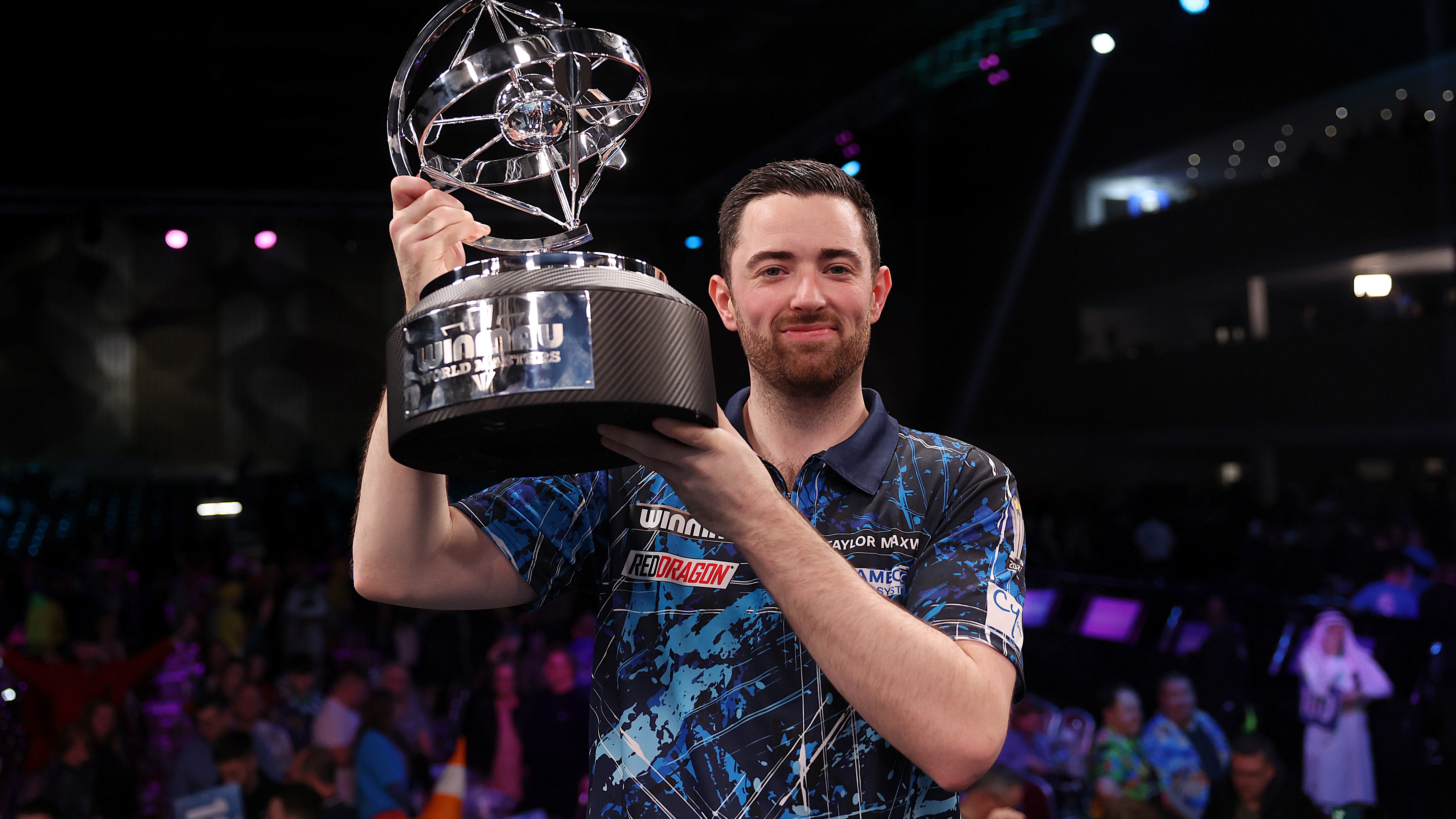 Luke Humphries of England with the trophy after winning the final of the 2025 Winmau World Masters at Marshall Arena on February 02, 2025 in Milton Keynes, England.