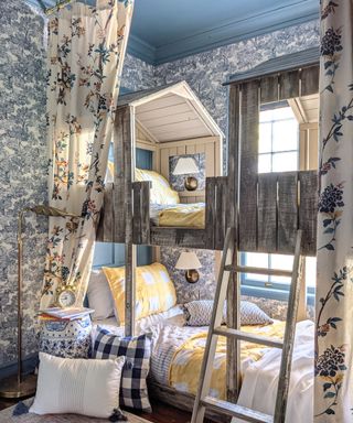Blue bunk room makeover with feature woodland wallpaper