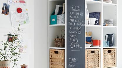 dark wood kitchen cabinets with spoons on the wall