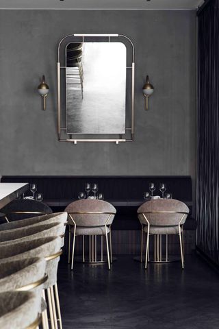 Seating area of restaurant with large mirror on the wall