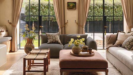 a large open living room in london with crittal patio doors and a refined Mediterranean style