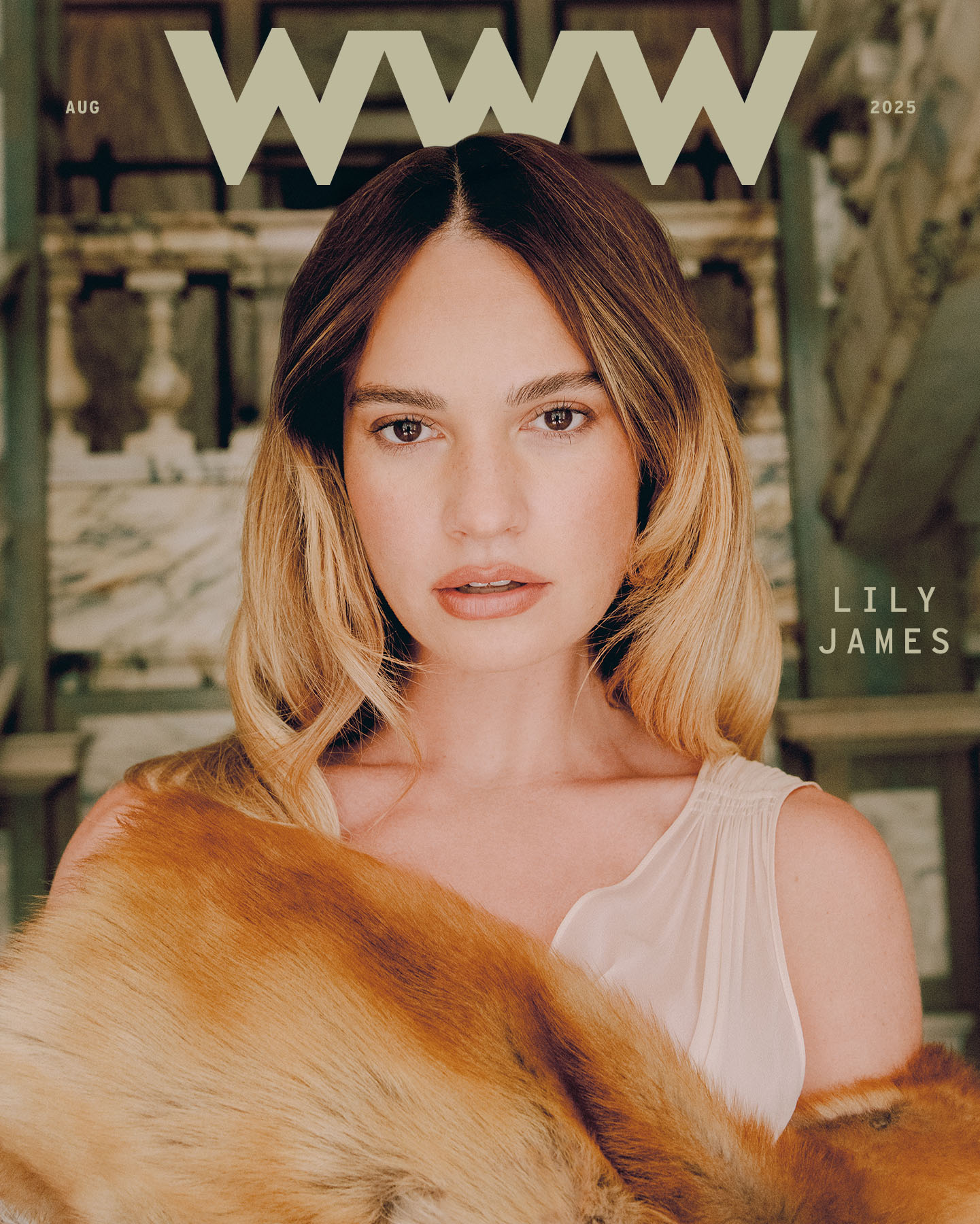 Cover image of Lily James from Who What Wear's August cover story. She is wearing a Saint Laurent faux fur coat and white dress.