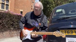 John Wines playing a Fender Stratocaster outside Jimmy Page&#039;s house