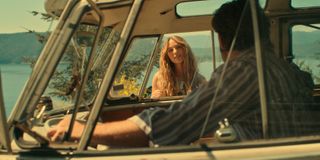 jessica rothe as sarah as she talks to callum kerr as everett through a window of his van in a virgin river season 6 flashback