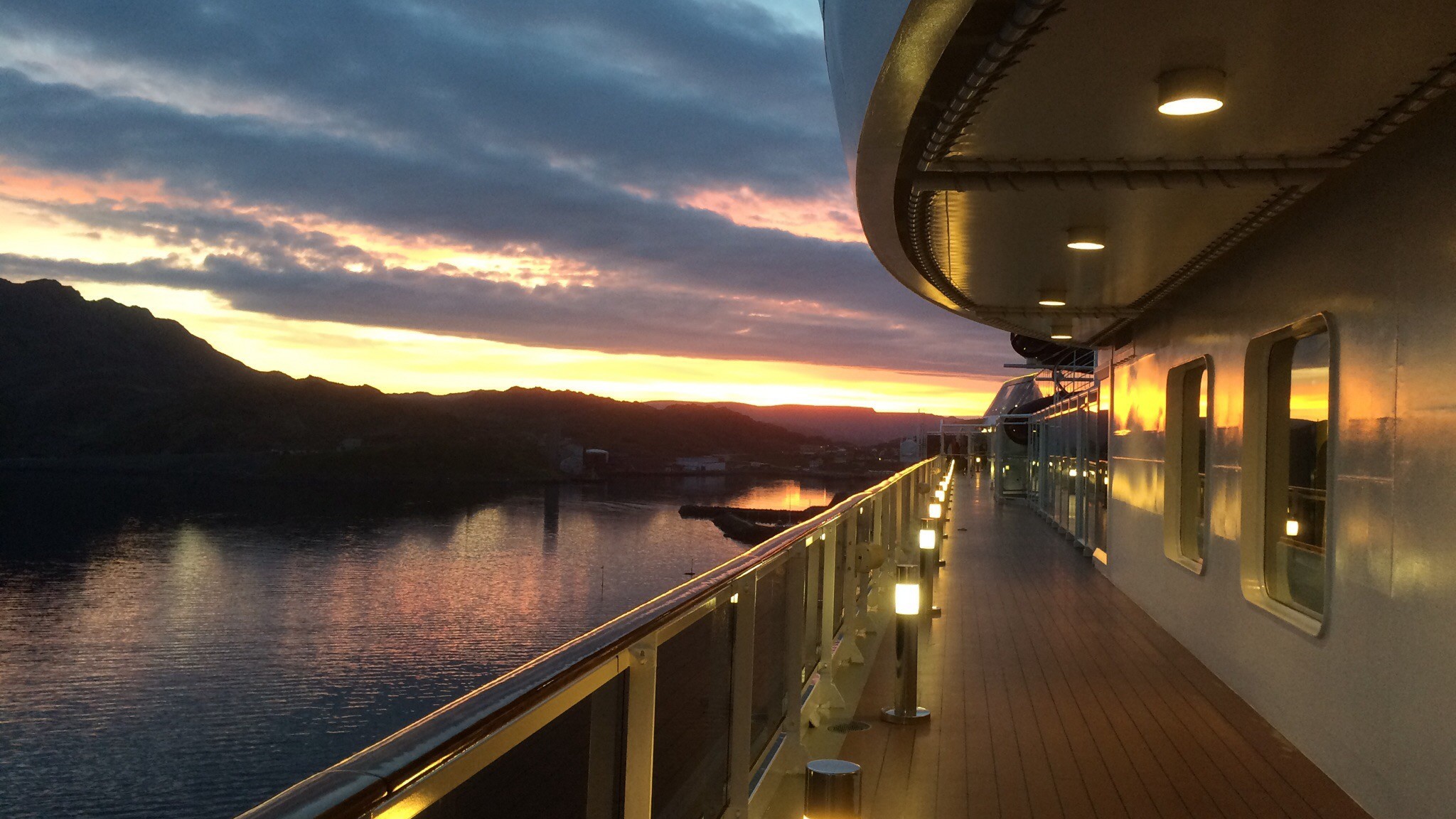 Cruise ship at sunset near the shores of a tropical island.