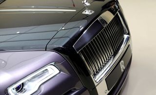 The bonnet of a Rolls Royce Ghost with focus on the brand logo and hood ornamet