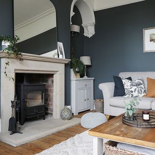 blue living room with fireplace and grey sofa