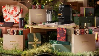 A Nespresso coffee machine surrounded by wrapped gifts and bags
