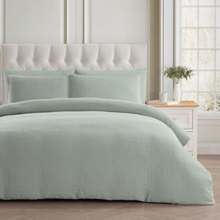 Light green bedding in neutral bedroom