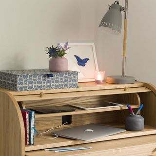 home office with desk and lamp and laptop and tab