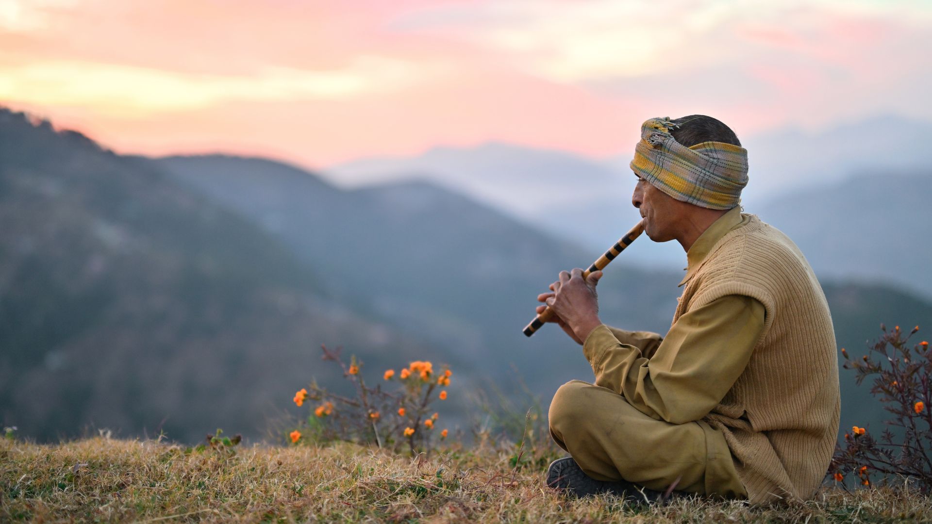 man playing flute in india
