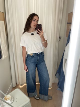 Anna LaPlaca wears a white T-shirt and wide-leg jeans from Madewell