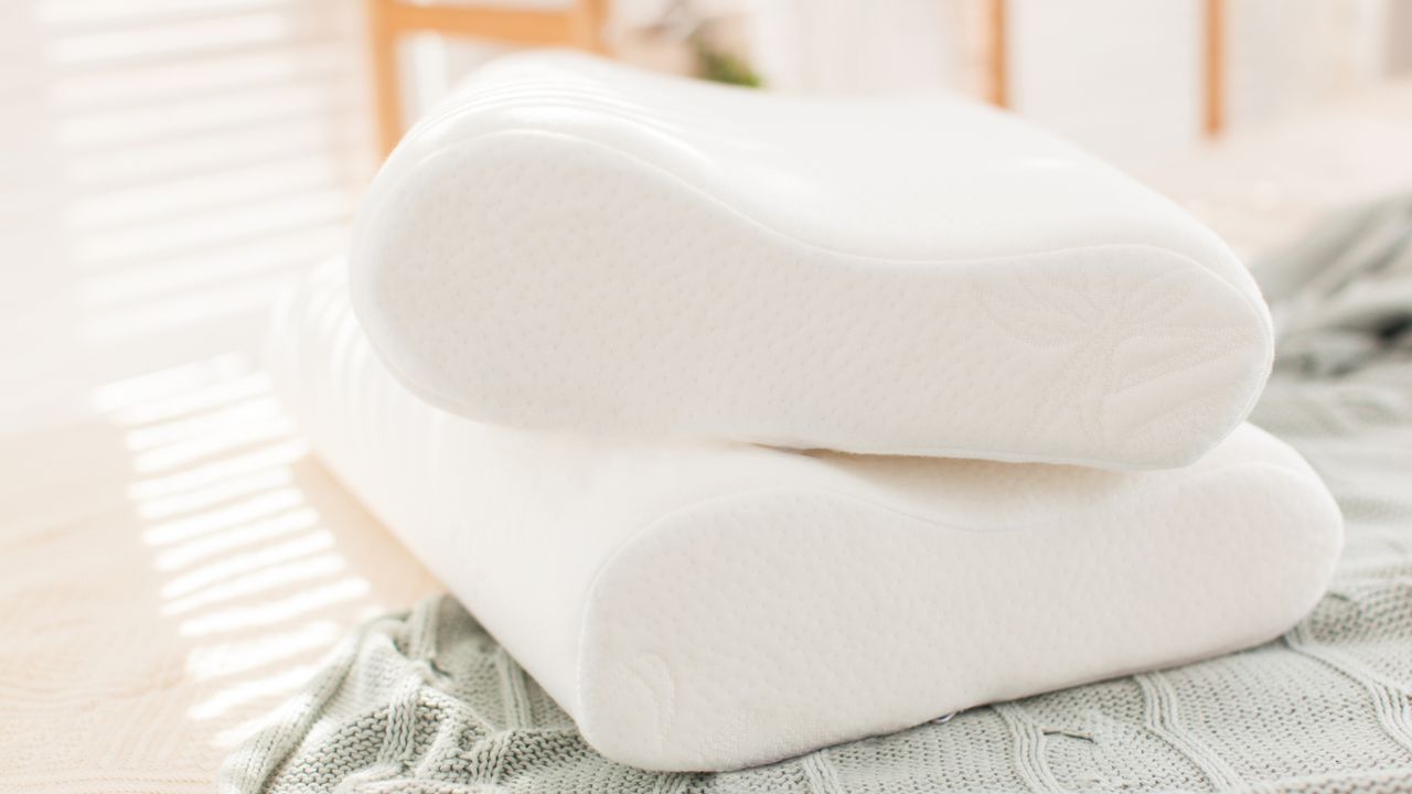 Memory foam pillows stacked on top of green blanket