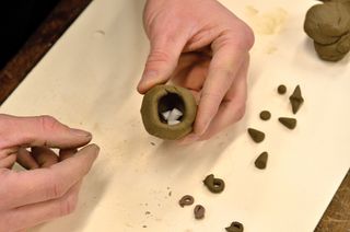 This photo shows Brian Zimerle, the Oriental Institute’s preparator and ceramicist, creating a modern day clay ball with tokens.