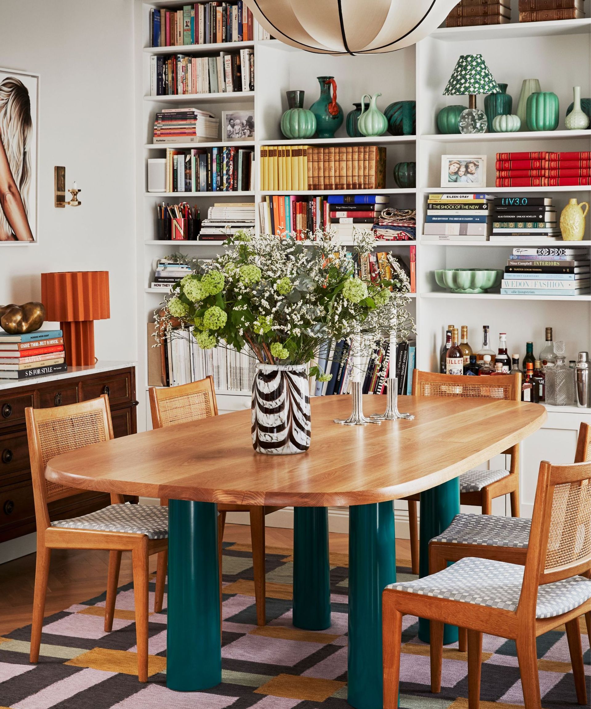 A dining room with a full bookcase