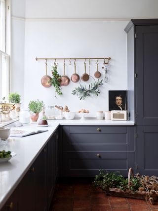 traditional-style kitchen with christmas decorations and copper pans hanging up