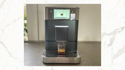 KitchenAid KF8 Fully Automatic Espresso Machine making an espresso, on a marble background