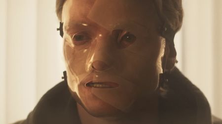 Clayface wearing plastic mask in Clayface
