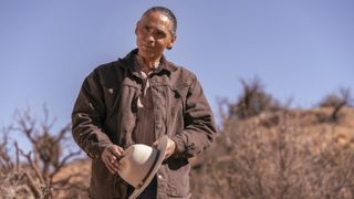 Zahn McClarnon as Joe Leaphorn in Dark Winds holding a hat in Dark Winds season 1