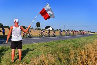 A fan watches the Tour de Pologne peloton roll by.