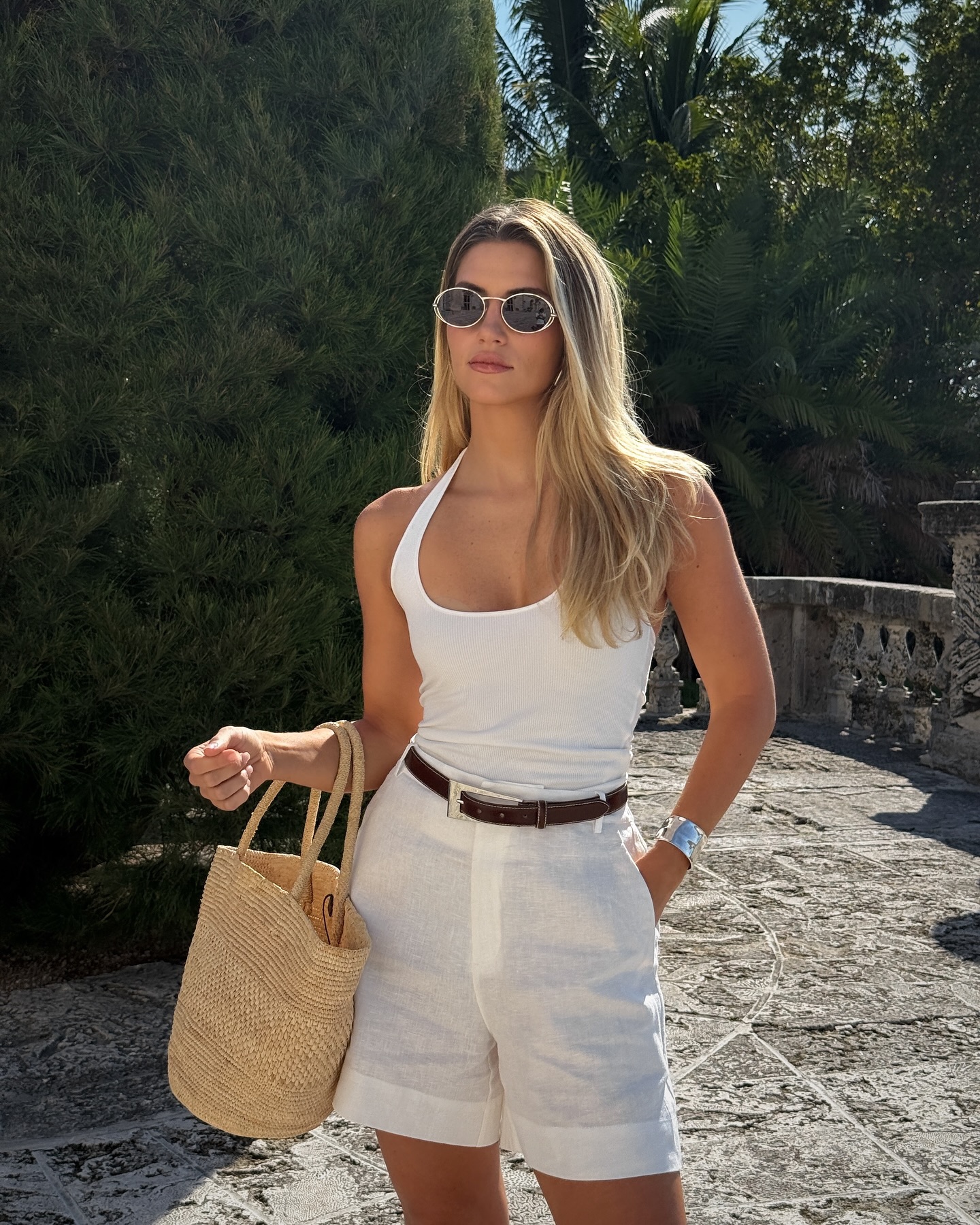 Cass in white vest and tailored shorts