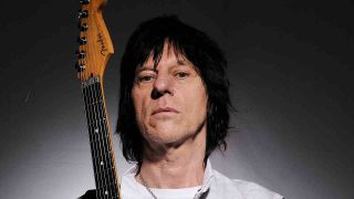 Jeff Beck posing for a photograph with a guitar in 2009