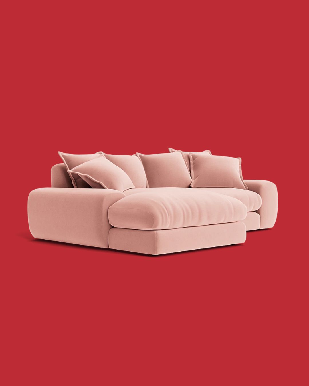 Wodge Modular Chaise Sofa in Strawberry Milkshake Pink against red background.