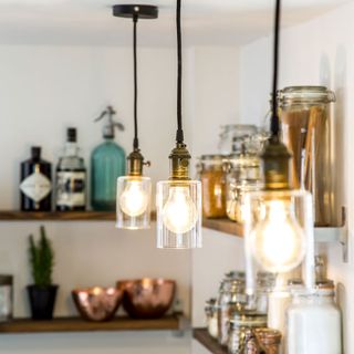 hanging bulbs with glass cover in kitchen