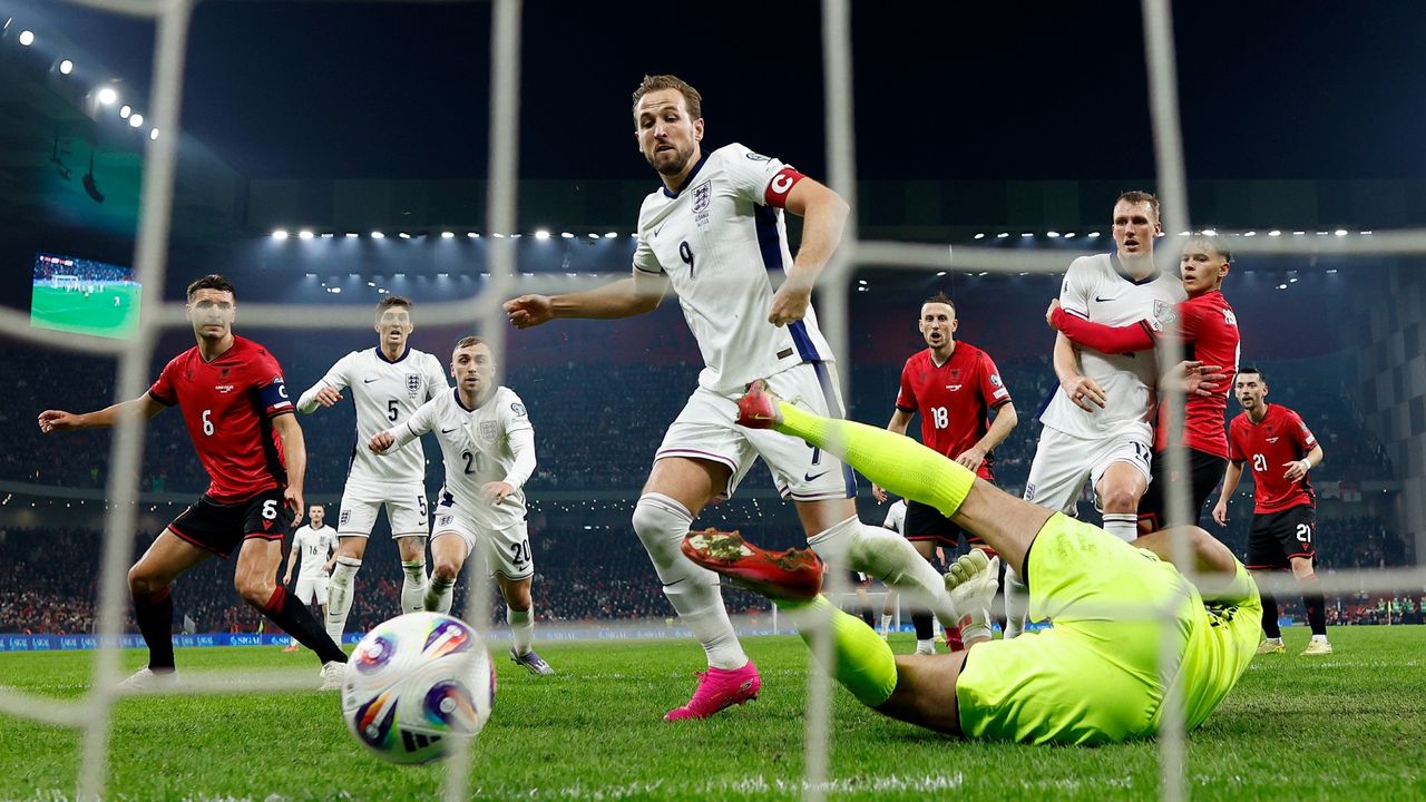  Harry Kane of England scores his team's first goal under pressure from Thomas Strakosha of Albania during the FIFA World Cup 2026 qualifier match between Albania and England