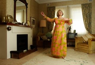 A woman dances in her living room