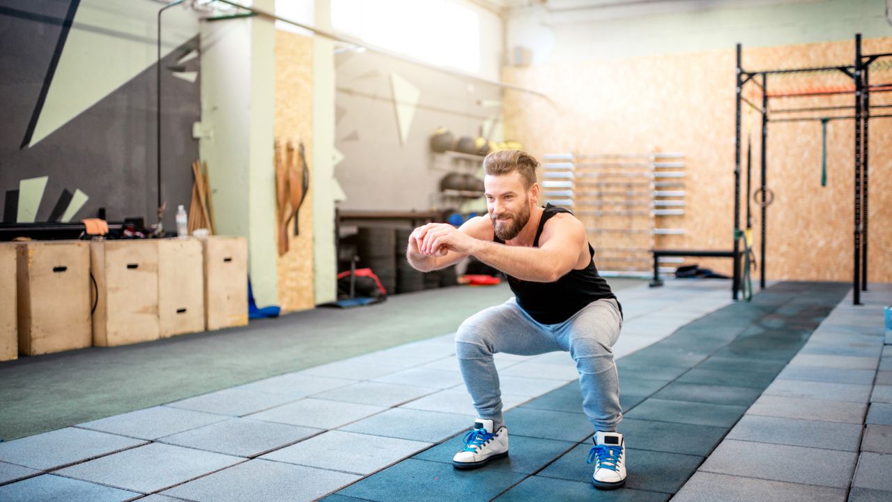 Man holding a squat